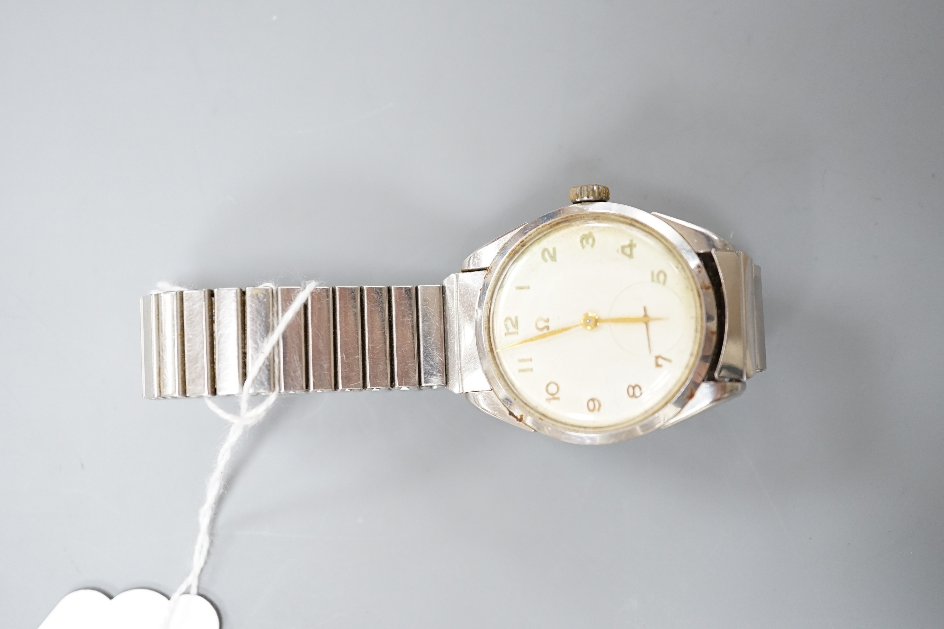 A gentleman's stainless steel Omega manual wind wrist watch, with Arabic dial and case back inscription, on associated flexible bracelet, case diameter 35mm.